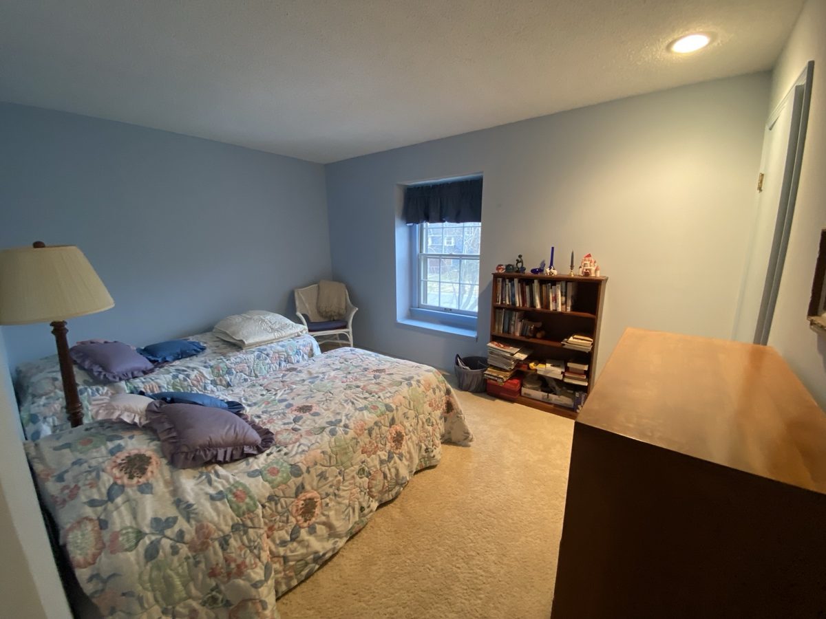 Before: cluttered bedroom with mixed furniture and busy decor