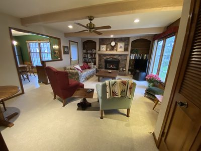 Before: living room with a dated red-brick fireplace and heavy furniture