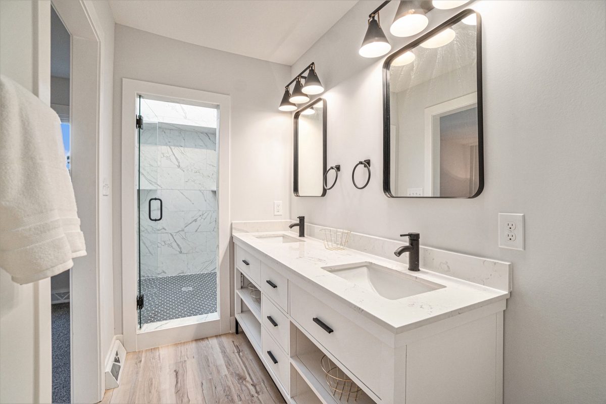 After: modern bath with a tiled walk-in shower and a new vanity