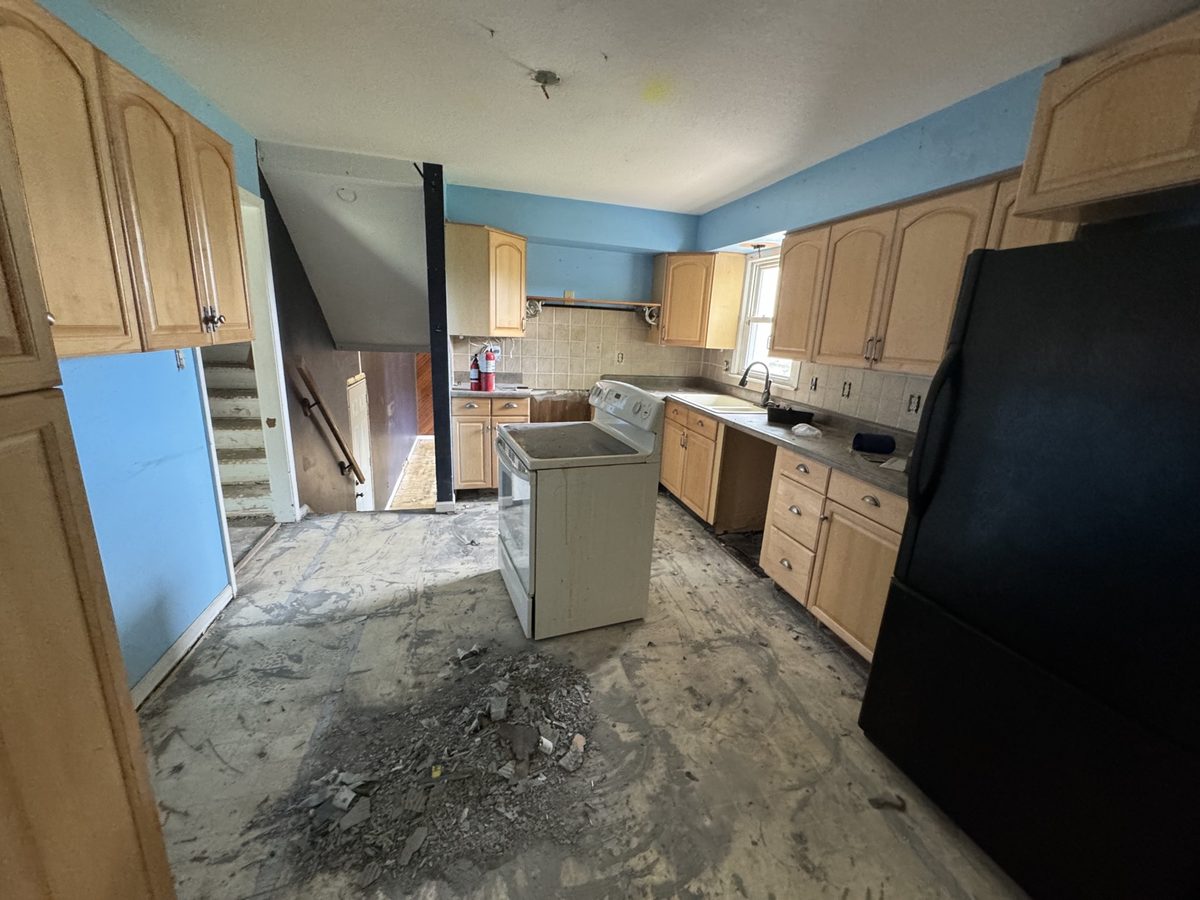 Before: dated kitchen with light wood cabinets, blue walls, and an old refrigerator